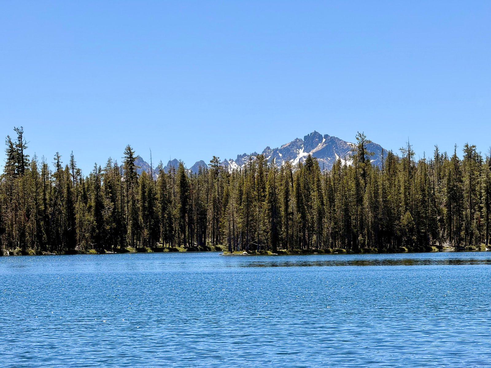 An alpine lake under summer Sierra peaks.