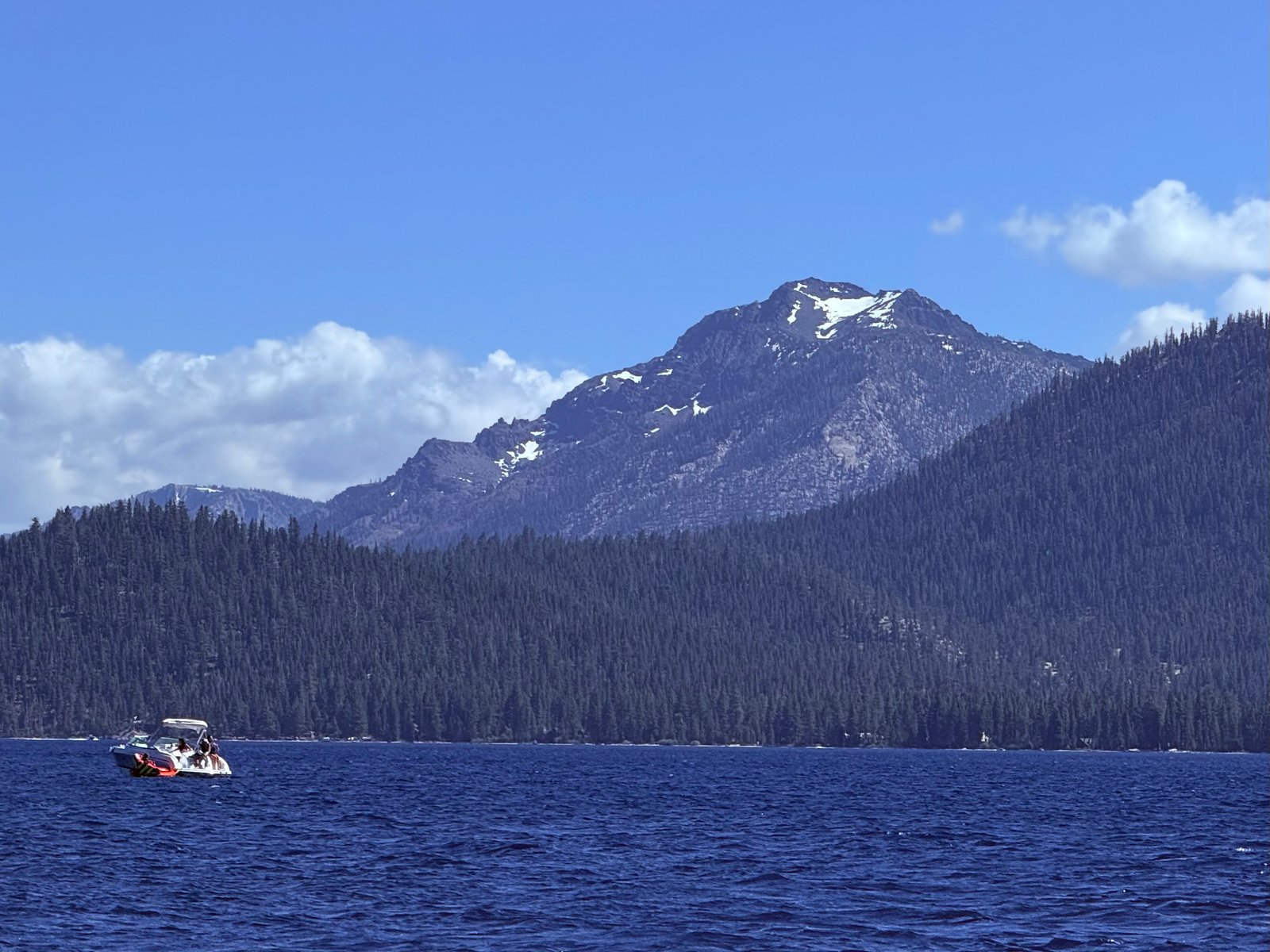 Lake Tahoe on a clear summer day, ridgelines visible in every direction — one place, many views.